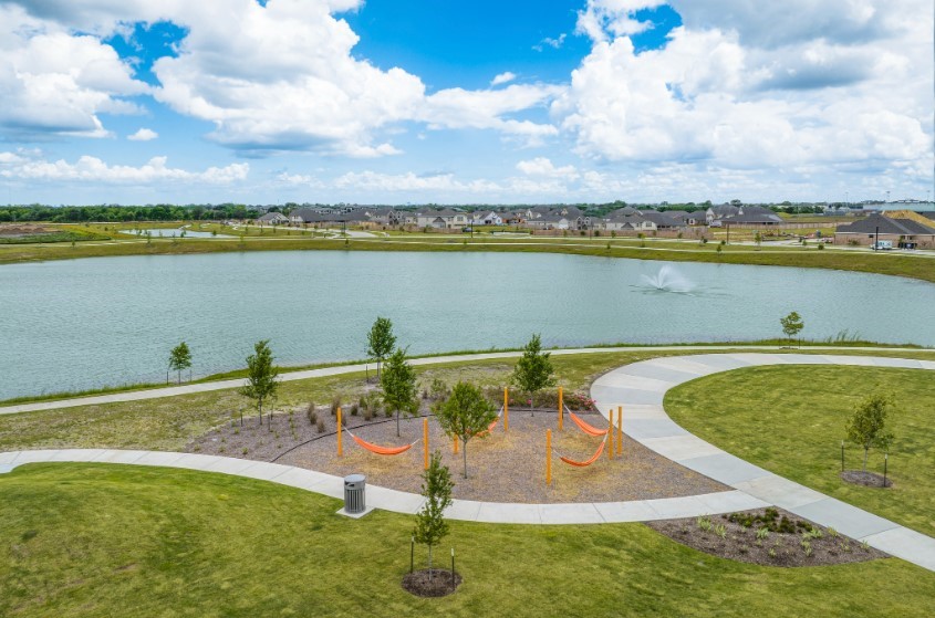 2923 Summer Breeze Way Angleton, TX 77515 - Photo 12 of 16 a view of a lake with houses in the back