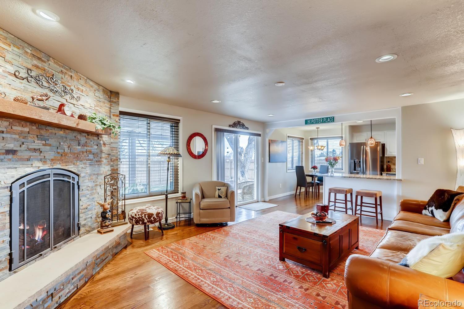 1502 Juniper Street Longmont, CO 80501 - Photo 14 of 28 a living room with furniture and a fireplace