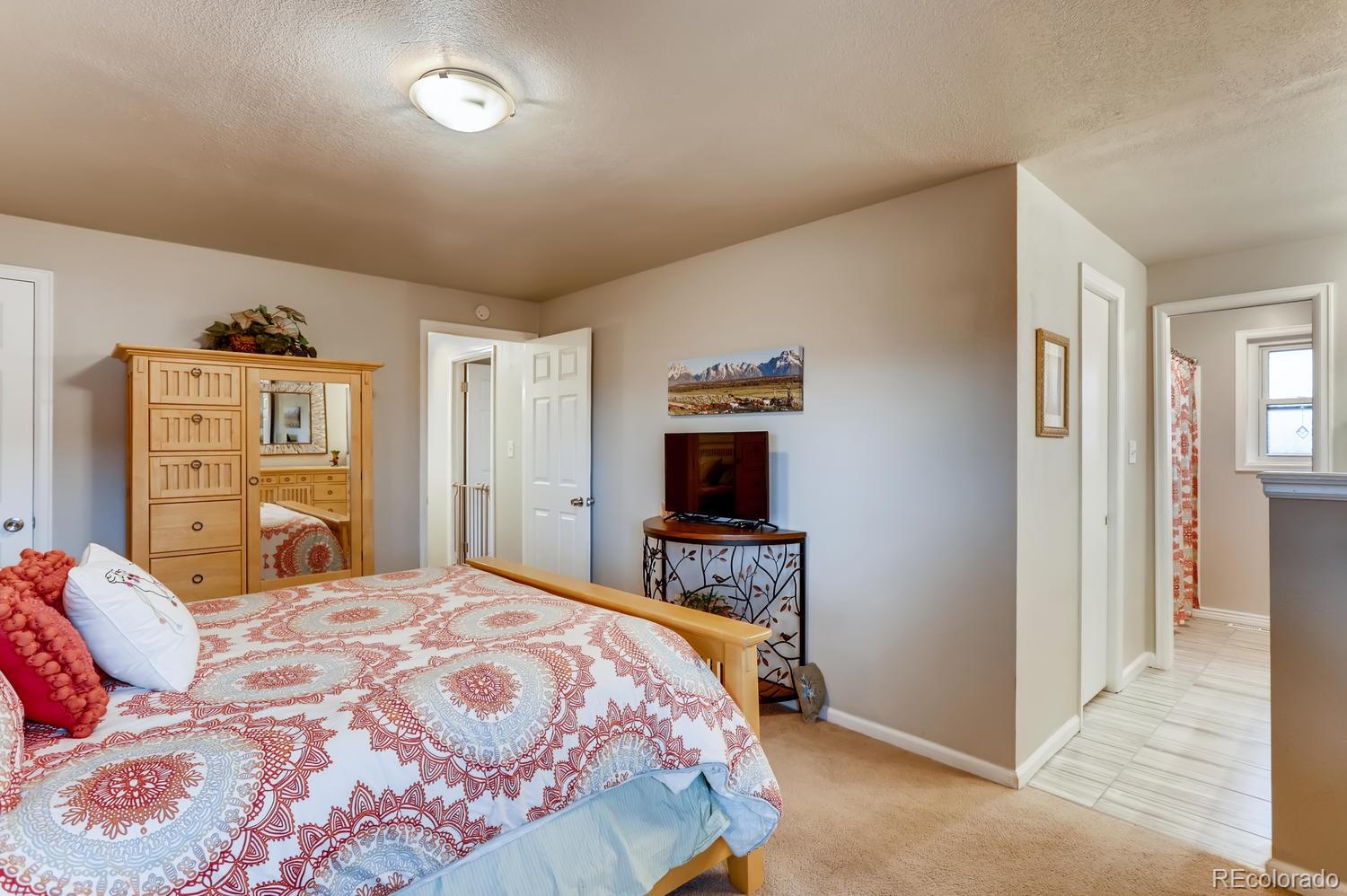 1502 Juniper Street Longmont, CO 80501 - Photo 17 of 28 a bedroom with a bed and a desk