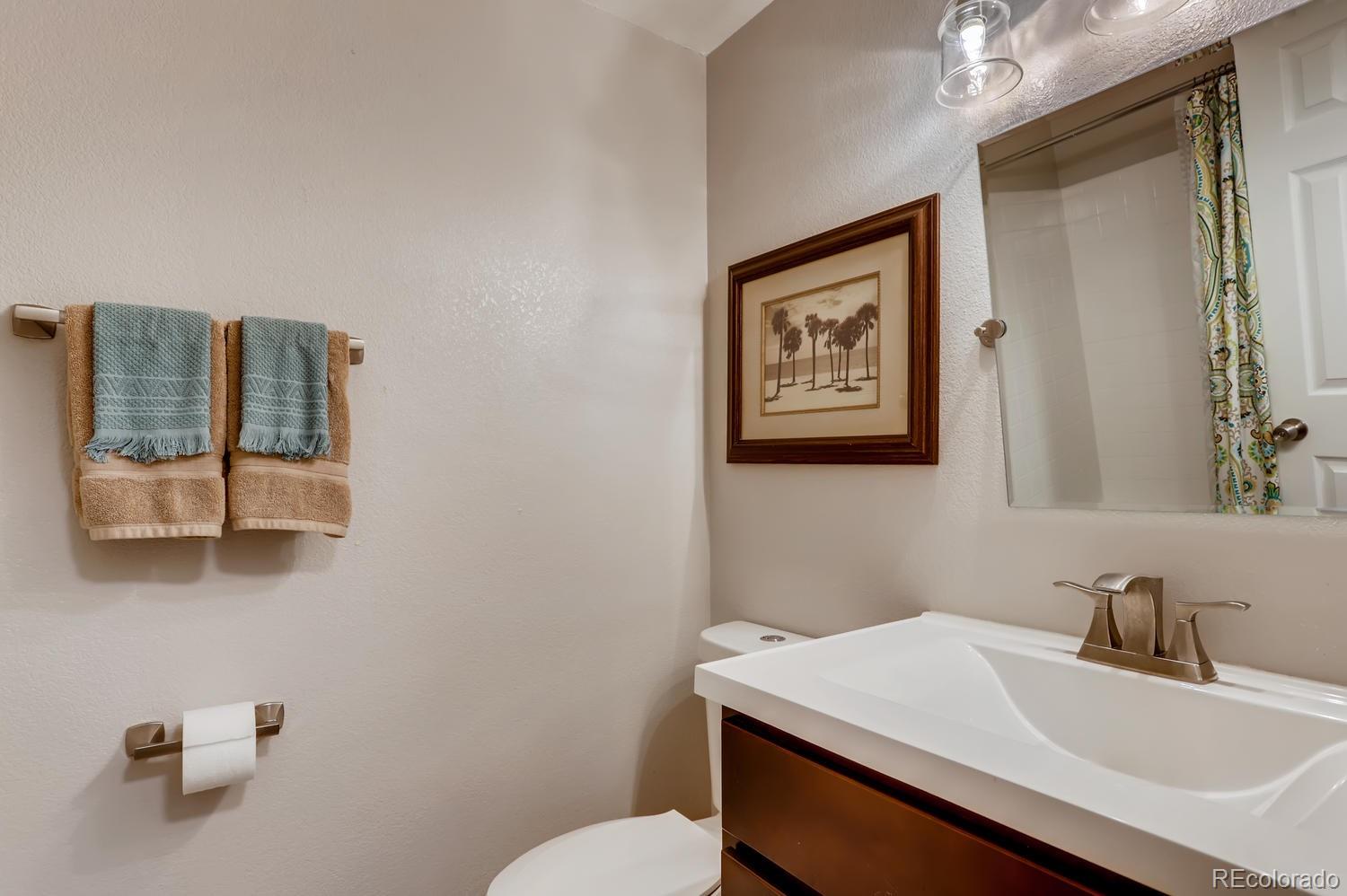 1502 Juniper Street Longmont, CO 80501 - Photo 20 of 28 a bathroom with a sink vanity mirror and toilet
