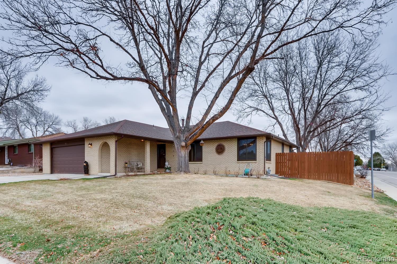 1502 Juniper Street Longmont, CO 80501 - Photo 2 of 28 a front view of a house with a yard covered in snow