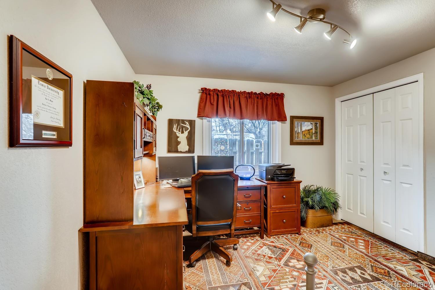 1502 Juniper Street Longmont, CO 80501 - Photo 21 of 28 a view of a workspace with furniture and a window