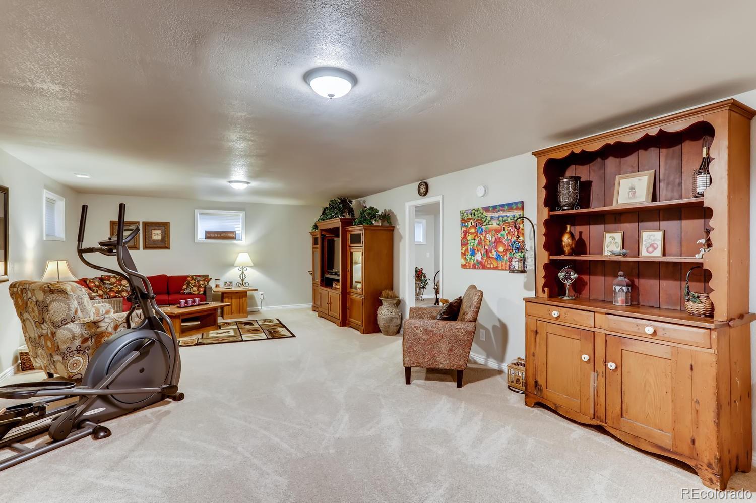 1502 Juniper Street Longmont, CO 80501 - Photo 22 of 28 a view of a livingroom with furniture and toys