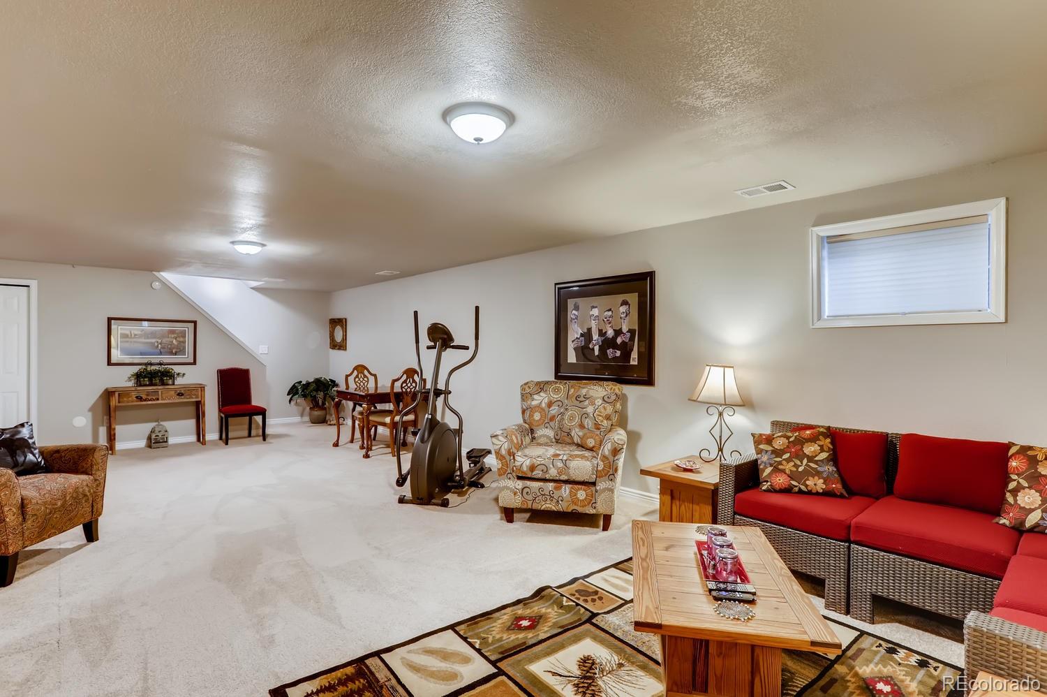 1502 Juniper Street Longmont, CO 80501 - Photo 23 of 28 a living room with furniture and a flat screen tv