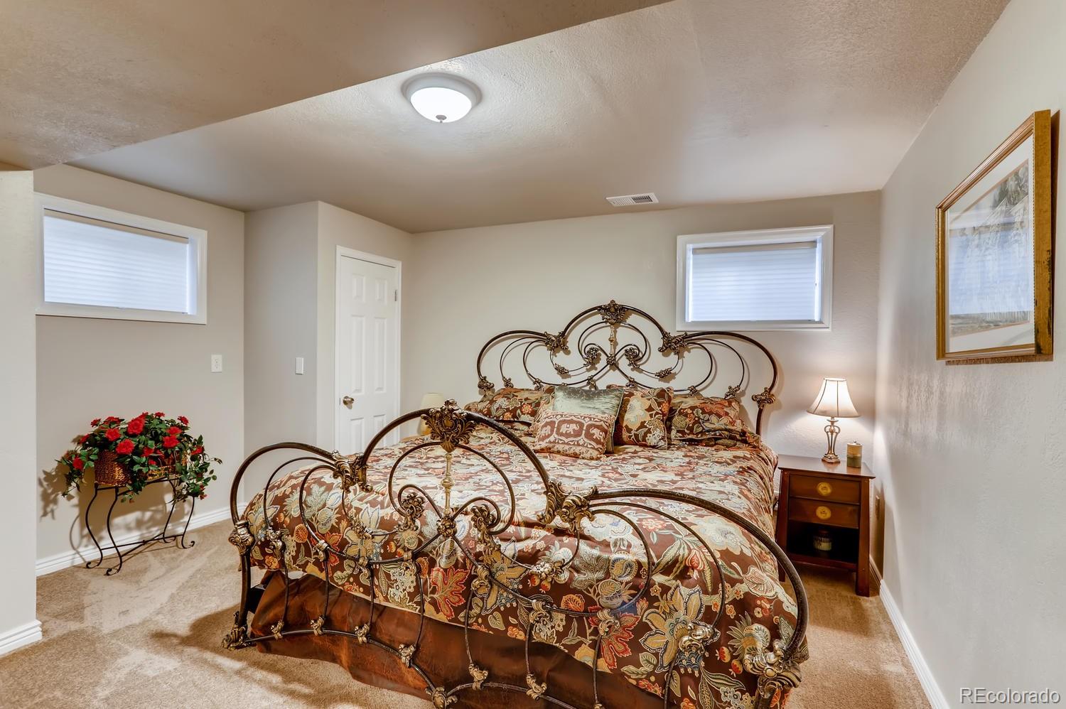 1502 Juniper Street Longmont, CO 80501 - Photo 24 of 28 a view of a bedroom with a bed and a potted plant