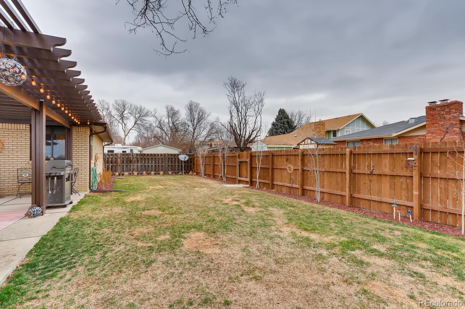 1502 Juniper Street Longmont, CO 80501 - Photo 25 of 28 a view of a yard with wooden fence
