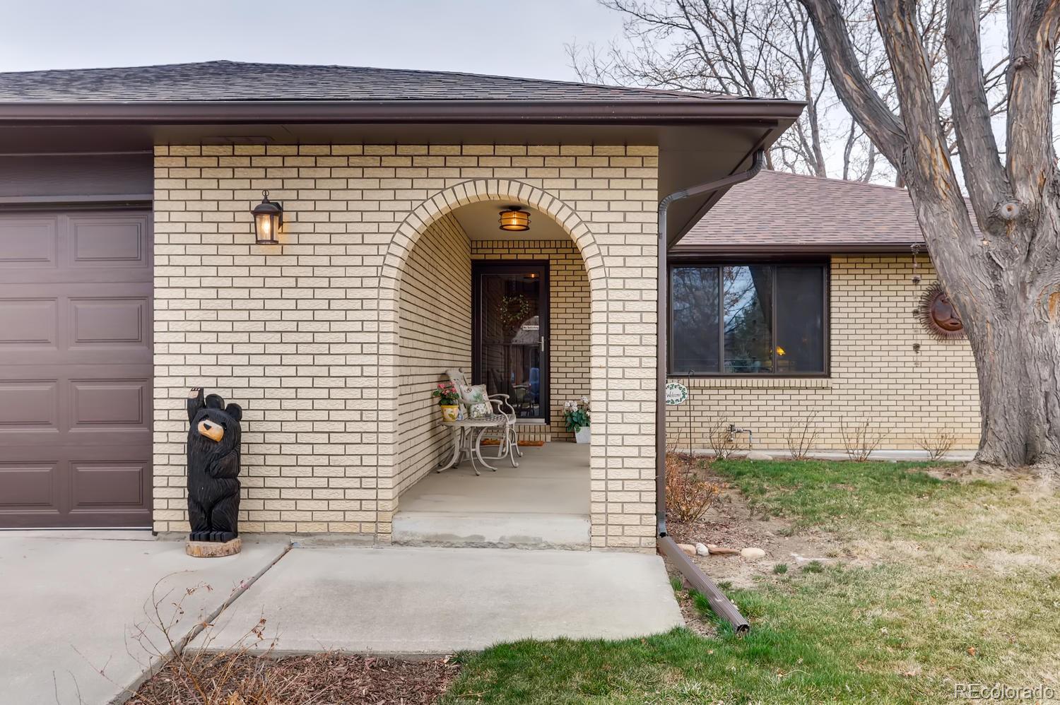 1502 Juniper Street Longmont, CO 80501 - Photo 4 of 28 a front view of a house with garden