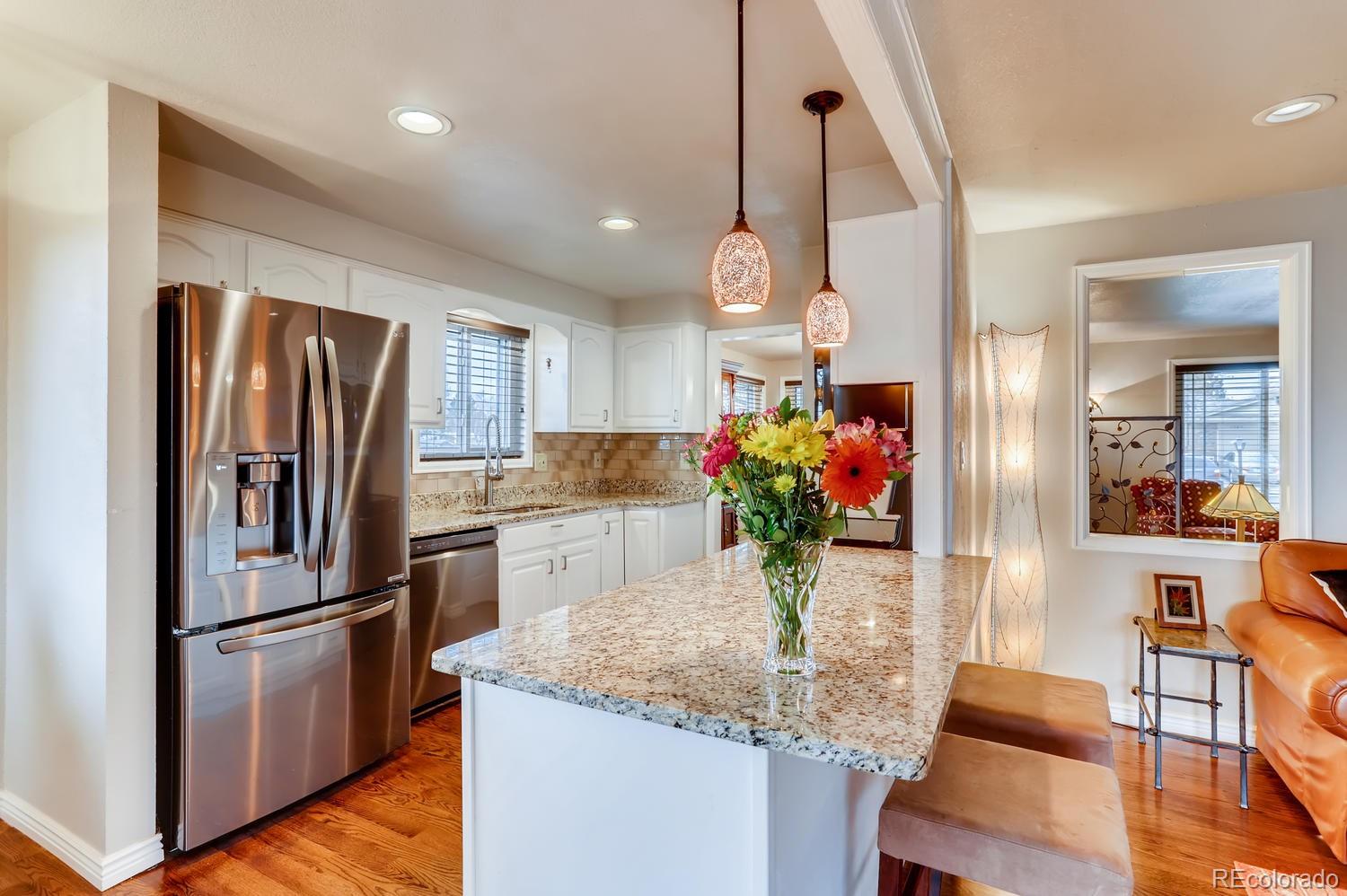 1502 Juniper Street Longmont, CO 80501 - Photo 10 of 28 a kitchen with refrigerator and microwave
