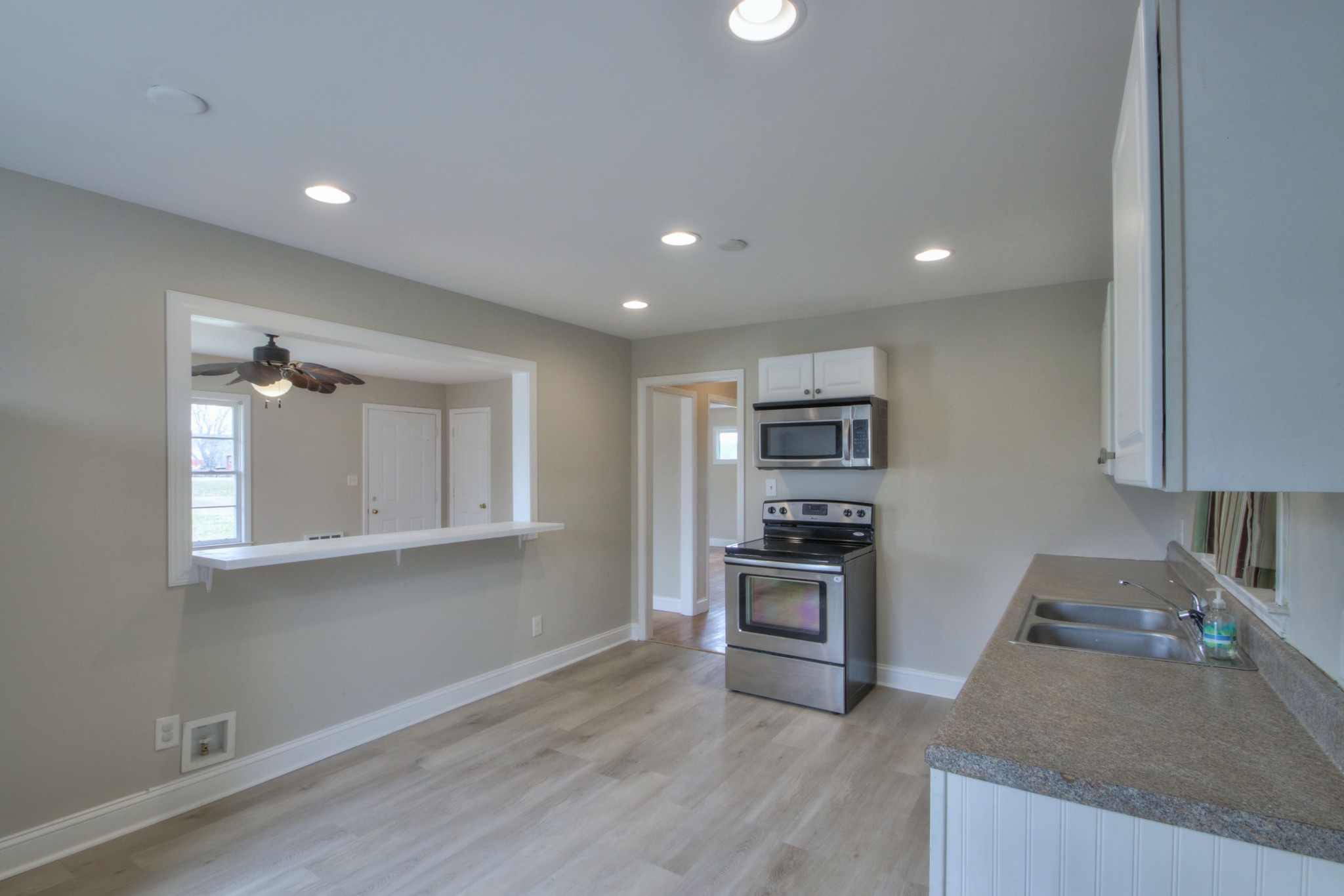 3885 Kedron Road Spring Hill, TN 37174 - Photo 4 of 32 a kitchen with stainless steel appliances granite countertop a stove a sink and a refrigerator