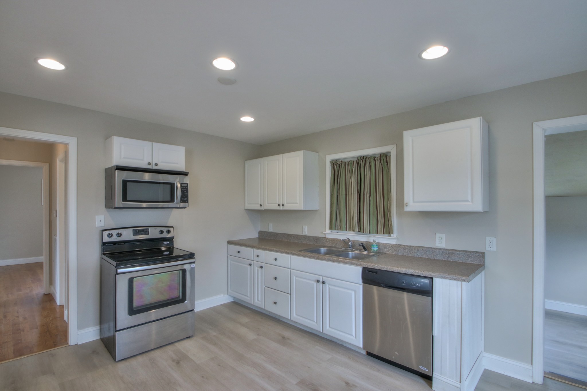 3885 Kedron Road Spring Hill, TN 37174 - Photo 5 of 32 a kitchen with granite countertop a sink and steel appliances