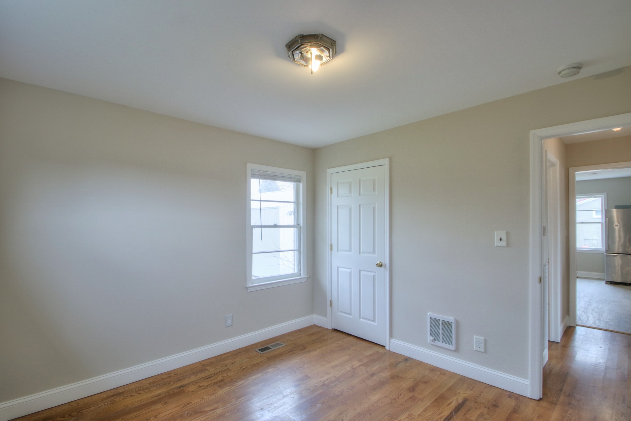 3885 Kedron Road Spring Hill, TN 37174 - Photo 7 of 32 an empty room with wooden floor mirror and windows