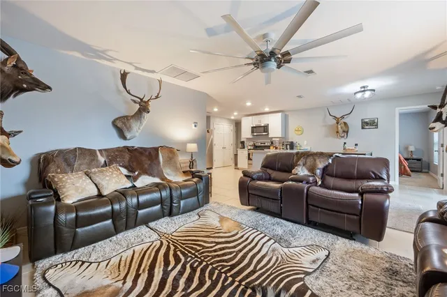 a living room with furniture and a ceiling fan