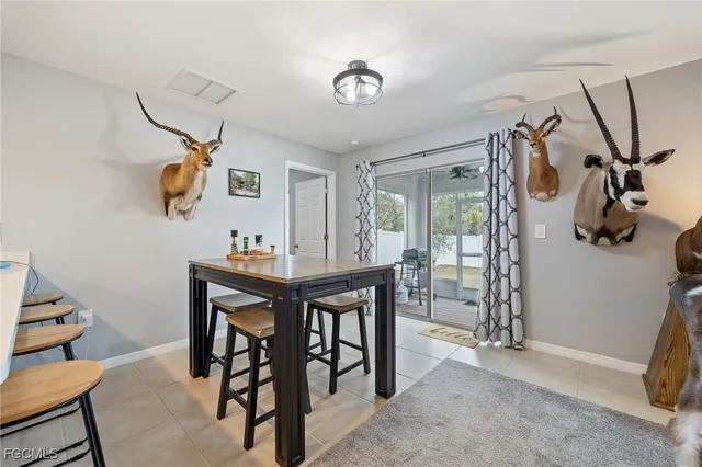 a view of a dining room with furniture and a chandelier