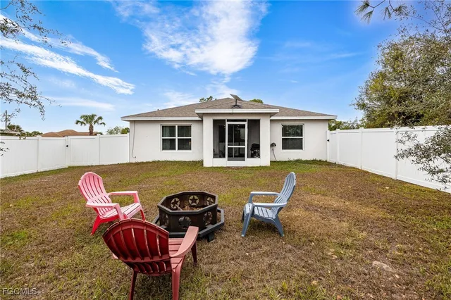 a view of a house with backyard space and sitting area