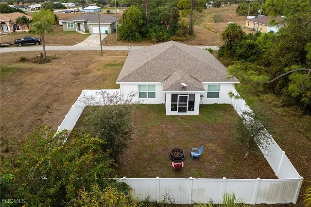 an aerial view of a house with yard