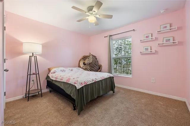 a bedroom with a bed dresser and a window