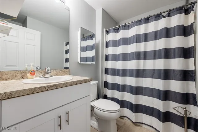 a bath room with a sink and a mirror