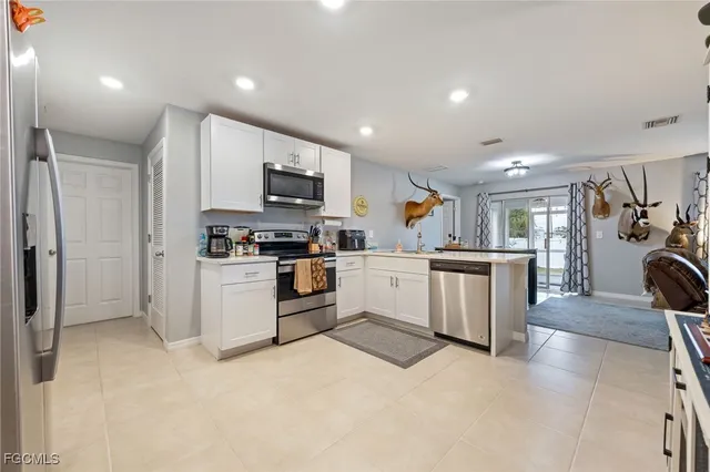a kitchen with microwave a sink and cabinets