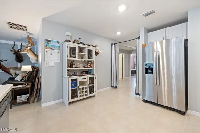 a view of empty room with furniture and entryway