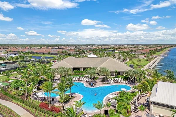 a view of swimming pool with outdoor seating and lake view