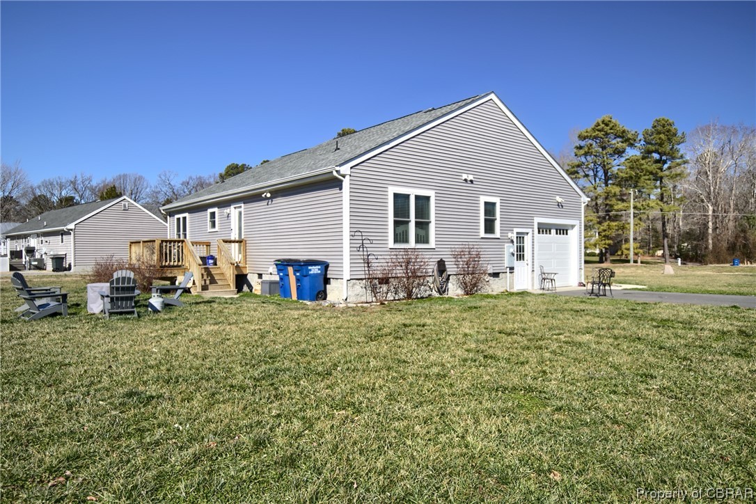 4944 Chestnut Fork Road Gloucester, VA 23061 - Photo 30 of 32 Rear view of property featuring a lawn and a deck