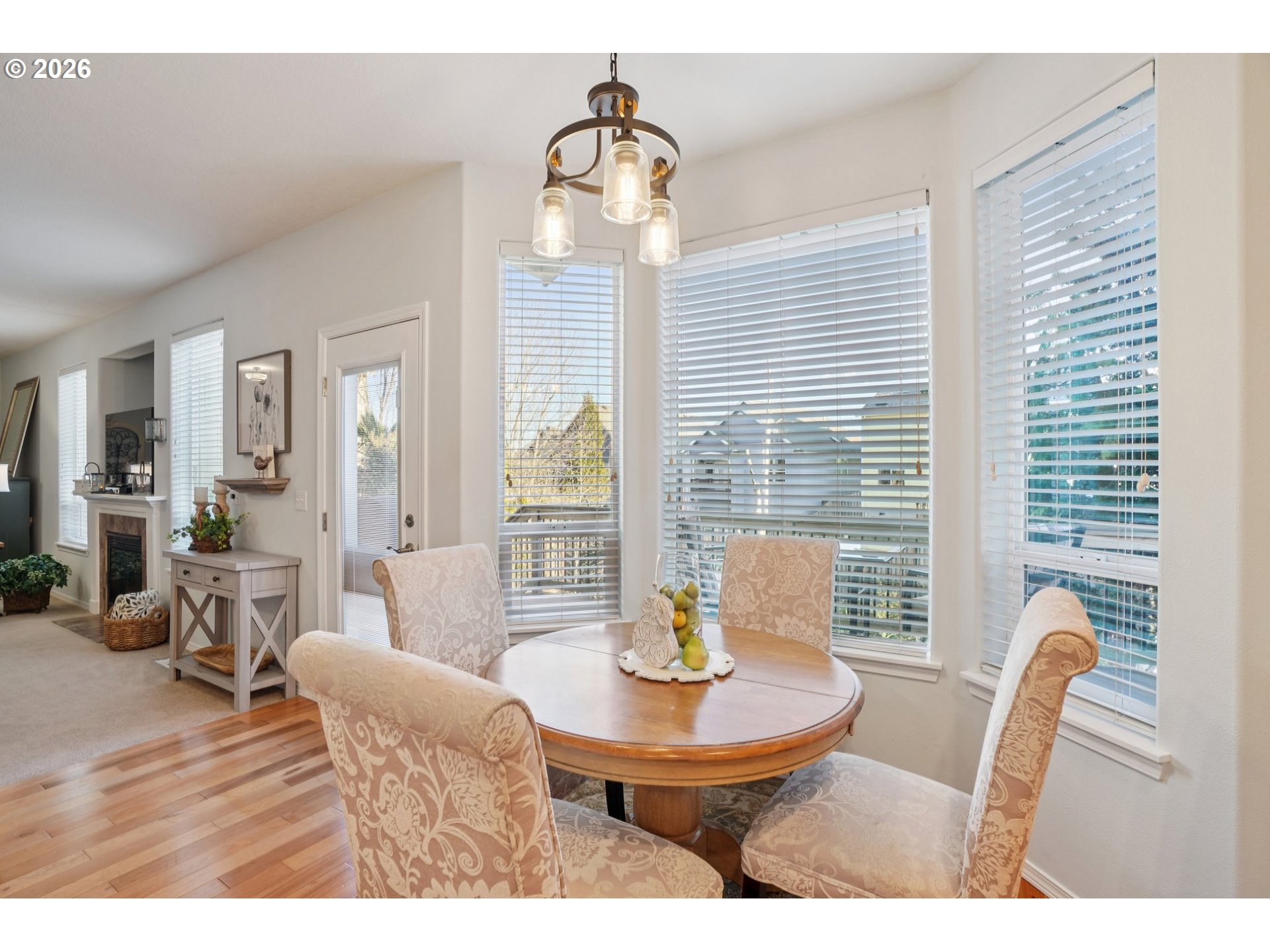 2404 Southeast Jasmine Way Gresham, OR 97080 - Photo 12 of 48 a view of a dining room with furniture window and wooden floor