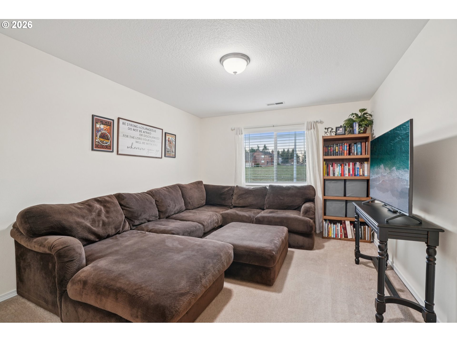 2404 Southeast Jasmine Way Gresham, OR 97080 - Photo 25 of 48 a living room with furniture and a flat screen tv
