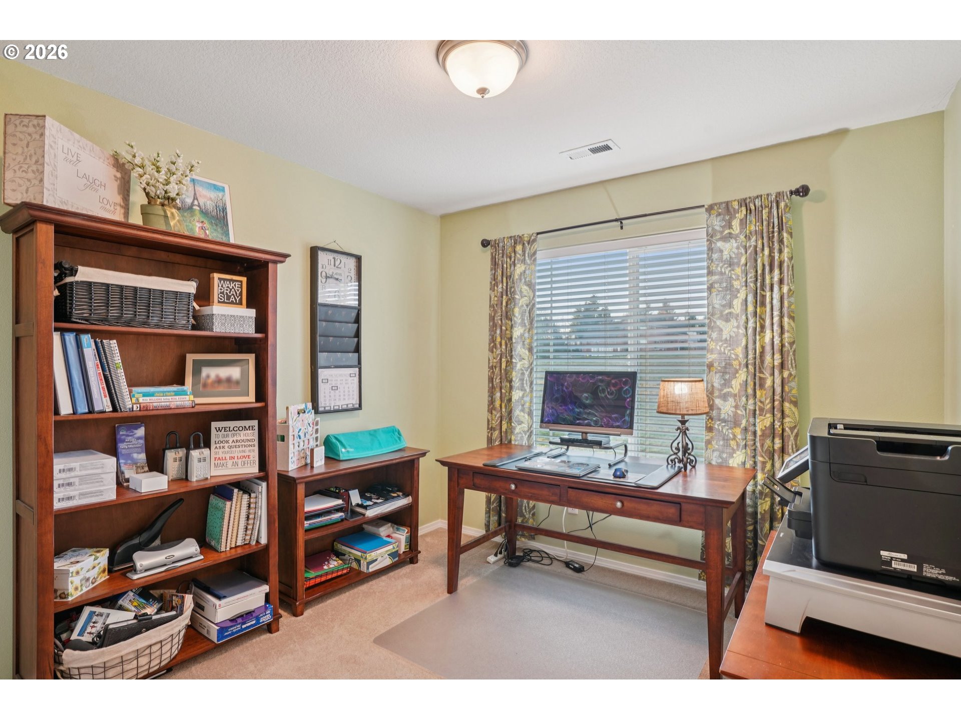 2404 Southeast Jasmine Way Gresham, OR 97080 - Photo 26 of 48 a living room with furniture a bookshelf and a window