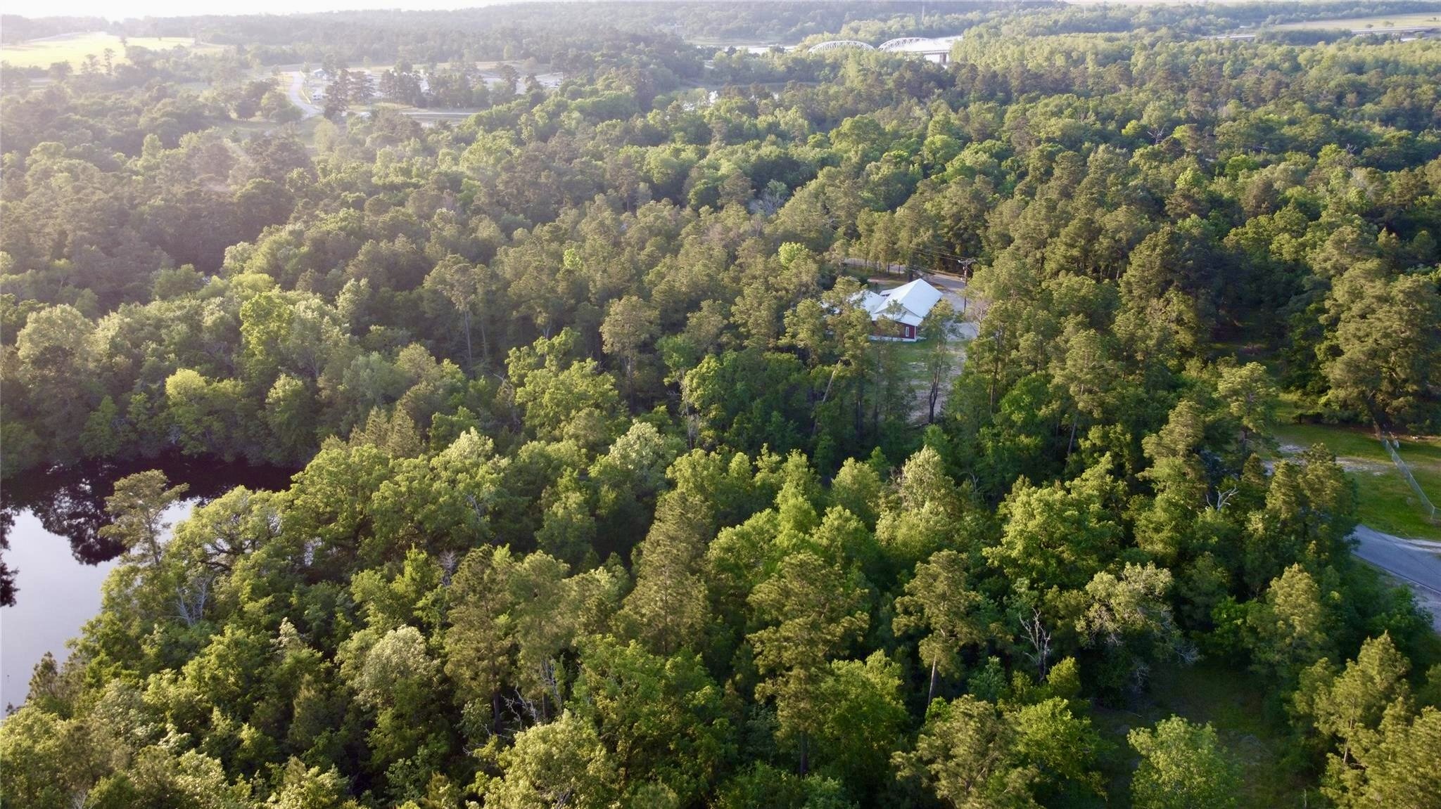 55 Lake Road Huntsville, TX 77320 - Photo 5 of 50 This photo captures Broyles Chapel showcases nestled in this lush, wooded land. This property offers lots of. privacy and a serene natural setting. The surrounding greenery and nearby water features make it ideal for nature lovers seeking tranquility.