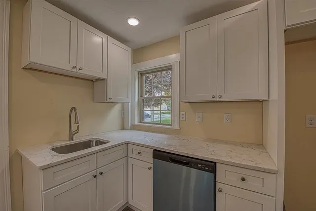 a kitchen with sink cabinets and window
