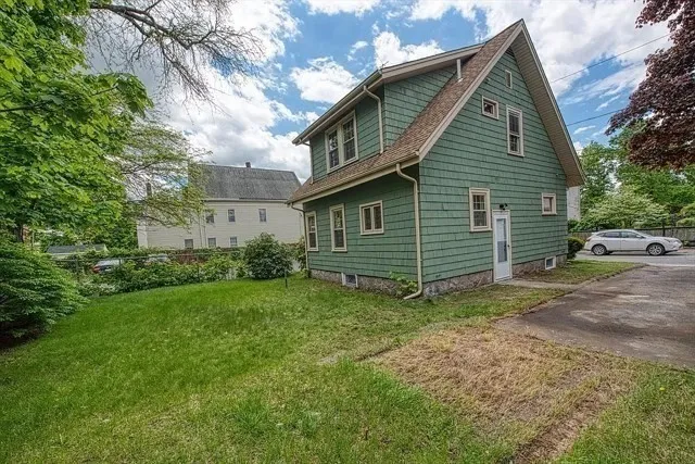 a view of a house with a backyard