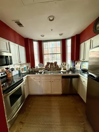 a kitchen with a sink a stove a microwave and cabinets