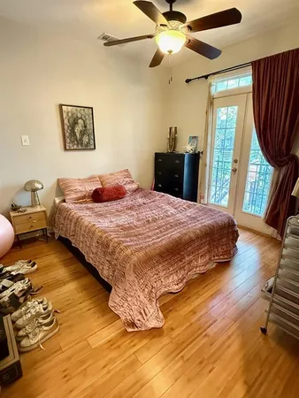 a bedroom with a bed a window and a walk in closet