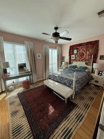 a bedroom with a large bed and a large window