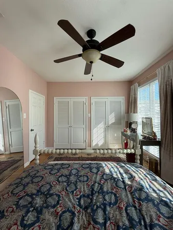 a bedroom with a bed and a large mirror