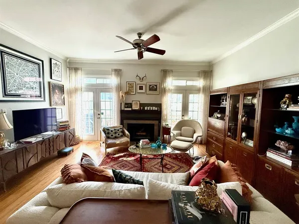 a living room with furniture a flat screen tv and a fireplace