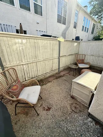 a backyard of a house with sofas