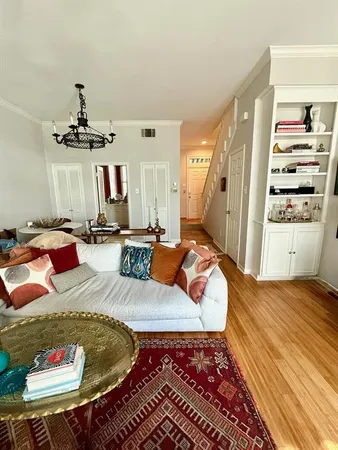 a living room with furniture and a chandelier