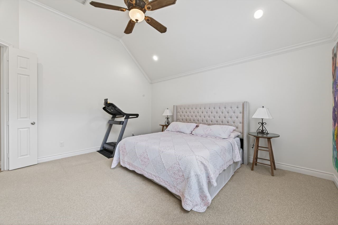 10932 Lasso Lane Houston, TX 77079 - Photo 15 of 38 a bedroom with a bed and ceiling fan