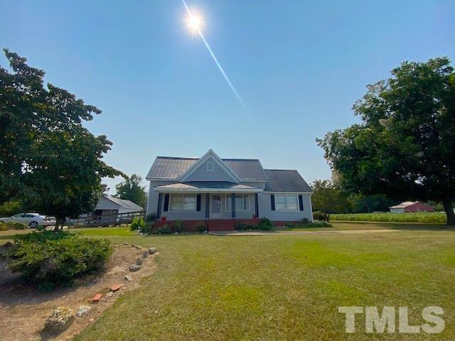 660 Noah Road Benson, NC 27504 - Photo 1 of 28 a front view of a house with a big yard