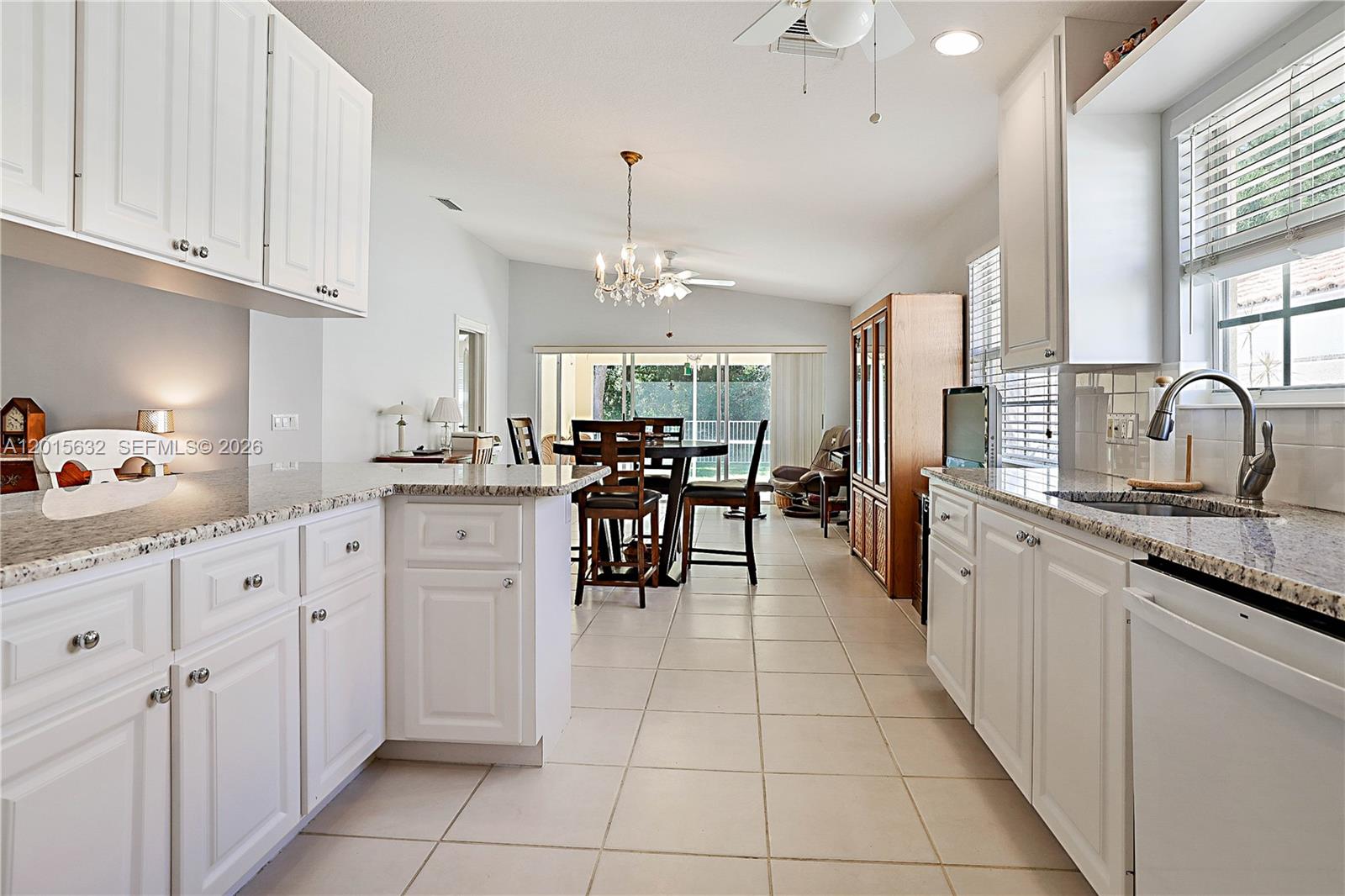 774 Southwest Balmoral Trace Stuart, FL 34997 - Photo 1 of 35 kitchen leads to dining area and family room with slider out to patio & peaceful private preserve view.