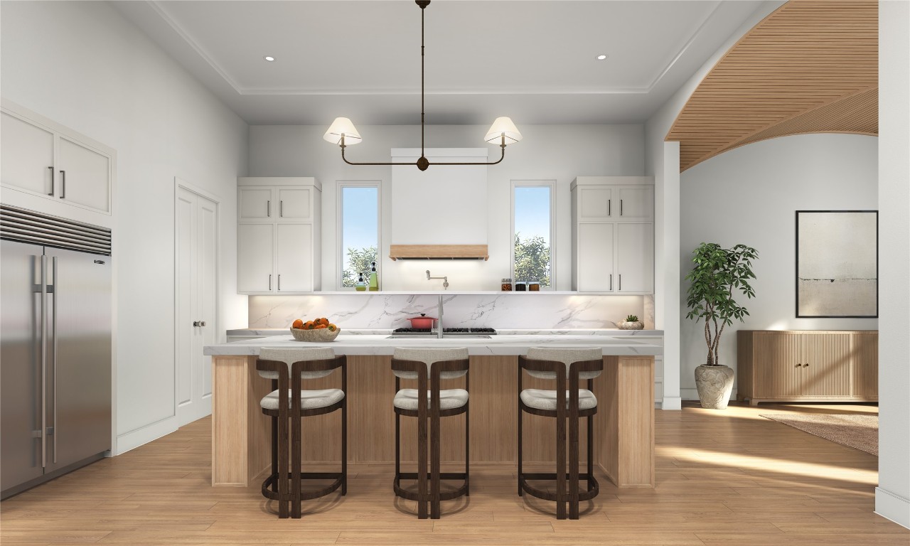 1016 East 27th Street Houston, TX 77009 - Photo 11 of 26 a kitchen with stainless steel appliances kitchen island a table chairs in it and wooden floors