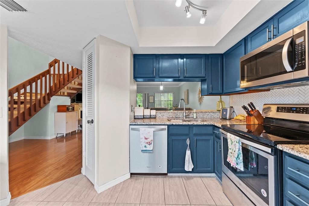 250 Woods Landing Trail Oldsmar, FL 34677 - Photo 11 of 45 a kitchen with stainless steel appliances granite countertop a stove and a sink