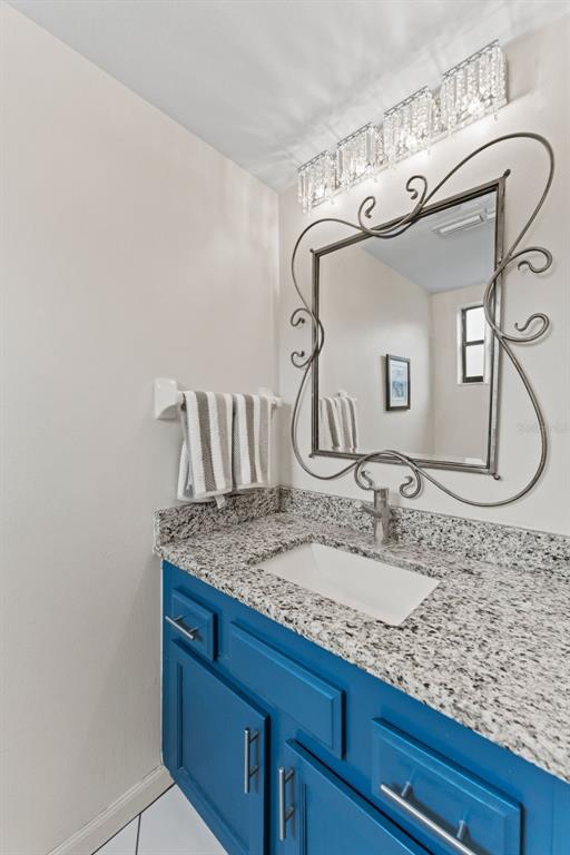 250 Woods Landing Trail Oldsmar, FL 34677 - Photo 26 of 45 a bathroom with a granite countertop sink and a mirror