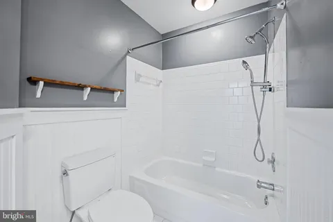 a bathroom with a shower a toilet and a shower