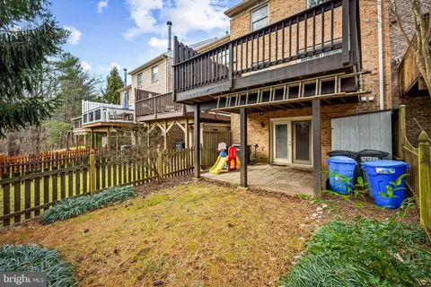 a view of a house with a small yard and a large tree