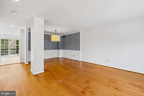 a view of a room with wooden floor and window