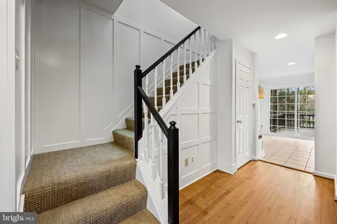 a view of entryway and hall with wooden floor