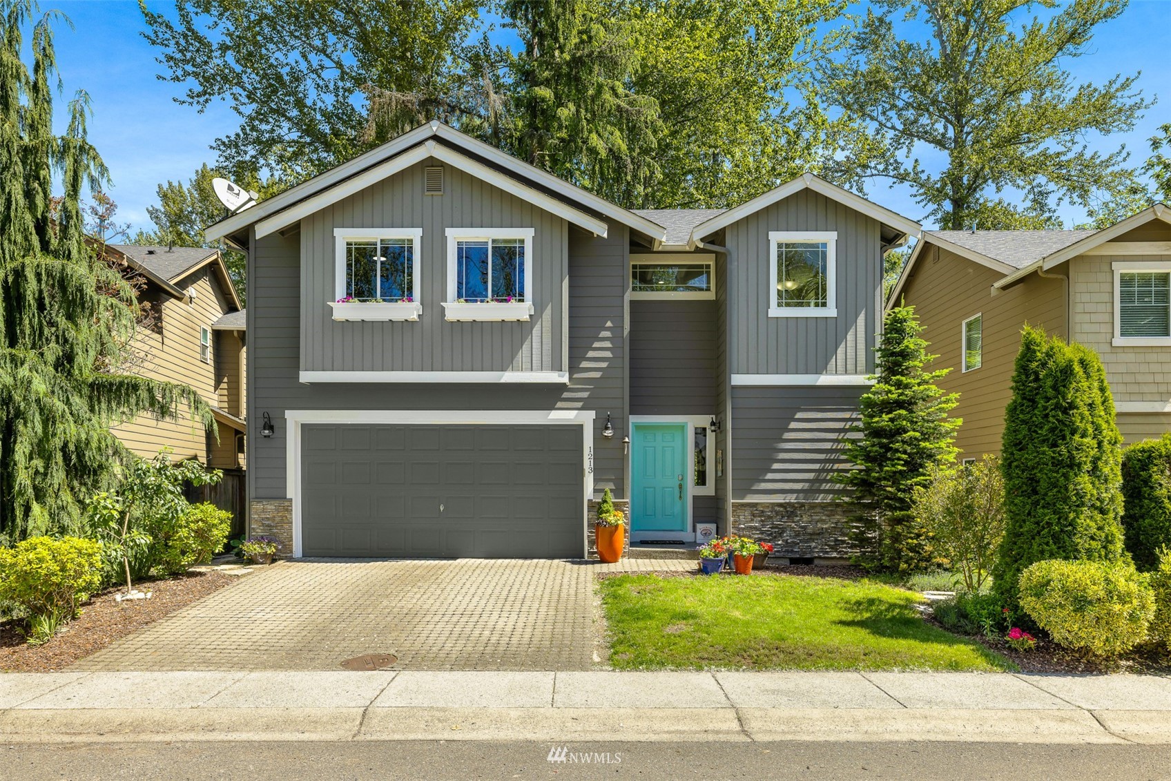 1213 231st Street Southwest Bothell, WA 98021 - Photo 1 of 33 a front view of a house with a yard and garage