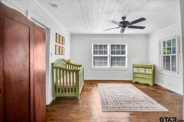 a living room with a bed and a window